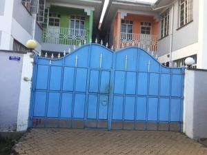 a blue gate in front of a building at Pacho Homestay in Kisumu