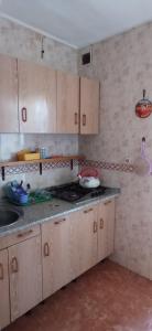 a kitchen with wooden cabinets and a counter top at Comfort Zone in Órgiva