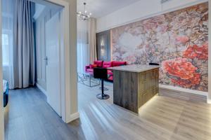 a living room with a large painting on the wall at Allure NOVA Aparthotel in Szczecin