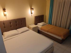 a hotel room with two beds and lights on the wall at Tekirova butik hotel in Kemer