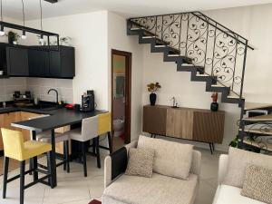 cocina y sala de estar con mesa y escalera en “Salotto Miano” - Intero Appartamento Arredato, en Pomigliano dʼArco