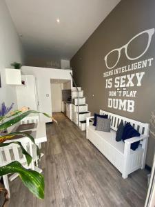a room with a bedroom with a couch and a staircase at Trendy Loft, El Dorm Apto. 434 in Guatemala