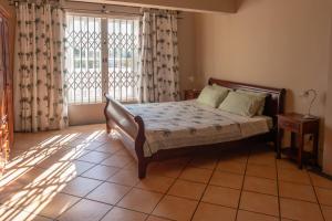 Voodi või voodid majutusasutuse Tamarin Seaside Apartment toas