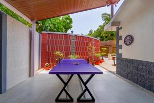 a purple table on the patio of a house at THE VENUE by Seasons Suites in Dod Ballāpur