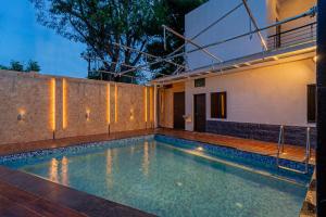 a swimming pool in the backyard of a house at THE VENUE by Seasons Suites in Dod Ballāpur