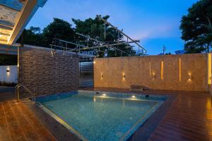 a swimming pool in a house with a brick wall at THE VENUE by Seasons Suites in Dod Ballāpur
