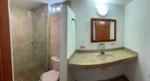 a bathroom with a sink and a shower and a toilet at Hotel Bahia Plaza in Santa Marta