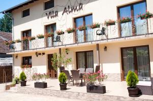 a building with flowers on the balconies at Vila Alma in Baile Felix