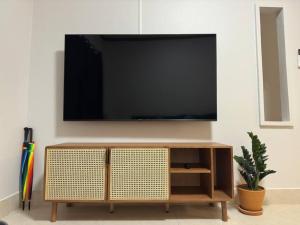 a living room with a television on a wall at Kathu Home with Mountain View in Kathu