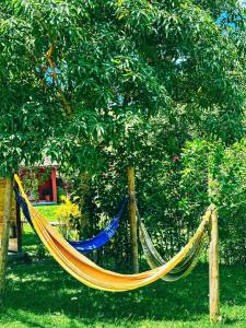 a hammock in front of a tree at Pousada Sítio da Floresta in Sana