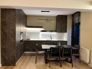a kitchen and dining room with a table and chairs at TOP-Apartments in Pristina