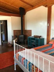 a bedroom with a bed and a stove in a room at Casita Luna in Santa Fe