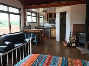 a living room with a couch and a kitchen at Casita Luna in Santa Fe