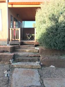 a porch of a house with stairs leading to a patio at Casita Luna in Santa Fe