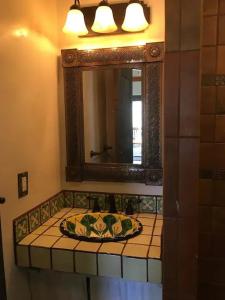 a bathroom with a sink and a mirror at Casita Luna in Santa Fe