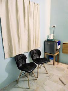 two black chairs in a room with a curtain at Kapar Homestay@Master Room/Private Bathroom/Private Car Park/1-2pax in Kapar