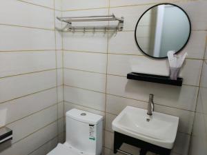 a bathroom with a white toilet and a mirror at Kapar Homestay@Master Room/Private Bathroom/Private Car Park/1-2pax in Kapar