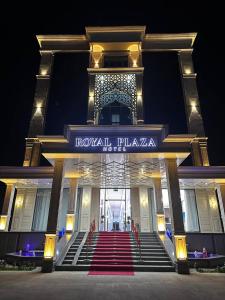 a building with a staircase in front of it with a sign at Royal Plaza in Qarshi