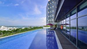 a swimming pool on the side of a building at Holiday Inn Haikou West Coast, an IHG Hotel in Haikou
