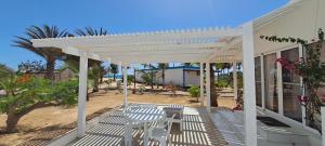 a white pergola on a porch of a house at KatlantiK Villa Deluxe in Sal Rei