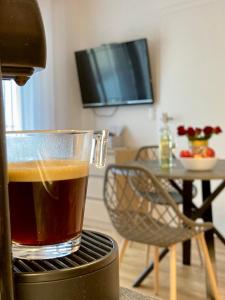 a cup of coffee sitting on top of a stove at Promenade by BestChoice - Self Check-in with Parking Option in Graz