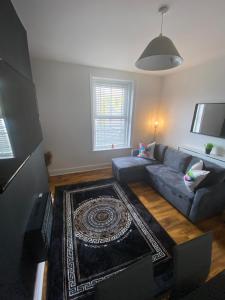 a living room with a couch and a rug at Luxevibe apartment in Blackpool