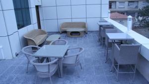 a group of tables and chairs on a patio at HOTEL BENI HAMAD in Bordj Bou Arreridj