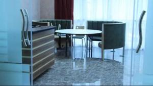 a dining room with a table and chairs at HOTEL BENI HAMAD in Bordj Bou Arreridj +3 photos