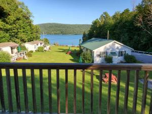 a view from the balcony of a house with a yard at Lake View Motel in Cooperstown