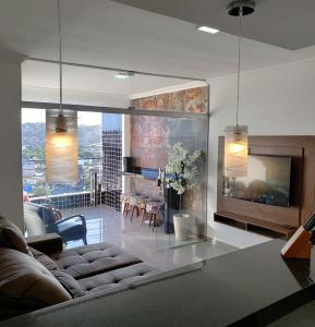 a living room with a couch and a living room with a fireplace at TH Flats GV Shopping in Governador Valadares