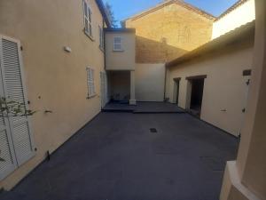 an empty parking lot in an alley between two buildings at Console Camprini Estates - Faenza Apartments 2 in Faenza