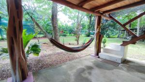 a hammock in a house with a garden at Marbella Beach (10min. walk) Nature Lovers & Surf in Marbella