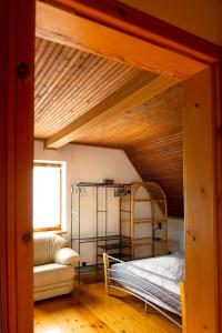 a bed in a room with a wooden ceiling at Biały Domek in Międzybrodzie Bialskie