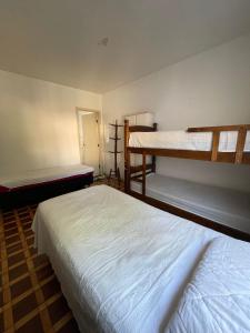 two beds in a room with two bunk beds at Quarto privativo ótima localização in São Paulo