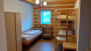 a room with two bunk beds and a window at Apartmán U Pekařů in Pec pod Sněžkou