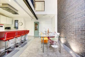 a kitchen and dining room with a brick wall at Shoreditch 3-Storey Maisonette - by Living Elite Apartments in Shoreditch