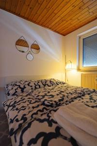 a bedroom with a bed and two lights on the wall at Tolle Wohnung mit Panoramablick in Weinheim