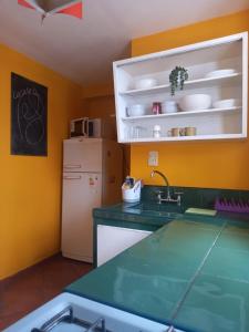 a kitchen with a sink and a refrigerator at Casa Porto in Mendoza