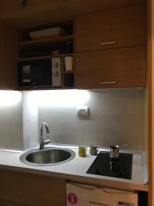a kitchen with a sink and a microwave at Planinski Raj - Bela Reka Gondola in Brzeće