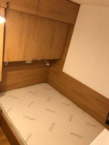 a bed in a room with a cupboard at Planinski Raj - Bela Reka Gondola in Brzeće