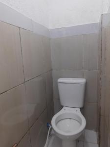 a bathroom with a white toilet in a room at Hotel SIMPLE in Manaus