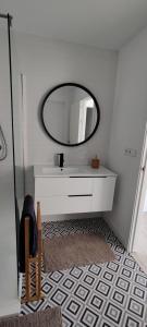 a bathroom with a sink and a mirror at IAROS Pueblo del Sol in Mogro