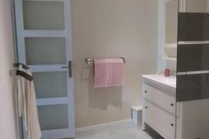 La salle de bains est pourvue d'une serviette suspendue à une porte de douche. dans l'établissement Studio attenant à Mas Provençal avec piscine, à Châteaurenard 19 autres photos