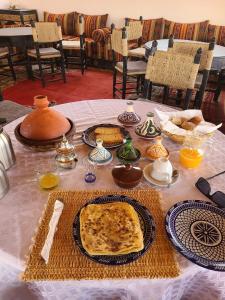 a table with bread and other food on it at Sahara wild camping in Mhamid