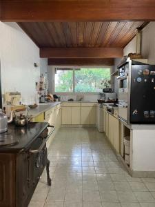 a large kitchen with a large window in it at Hosteria La Chacra in Esquel