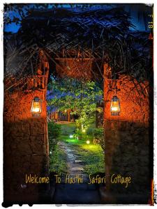 a night picture of a pathway in a garden at Hasthi Safari Cottage in Udawalawe