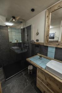 a bathroom with a shower and a sink and a mirror at La Casa del cuore in Fenis