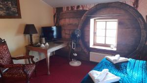 Zimmer mit einem Schreibtisch und einem Fenster in einem Zimmer in der Unterkunft Hotel Spichrz in Borcz