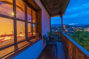 a room with a balcony with a bed and a view at Manzara Konak Otel in Safranbolu