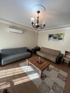 a living room with two couches and a coffee table at Удобная квартира для семьи Comfortable apartment for a family شقة مريحة لعائلة in Yalova